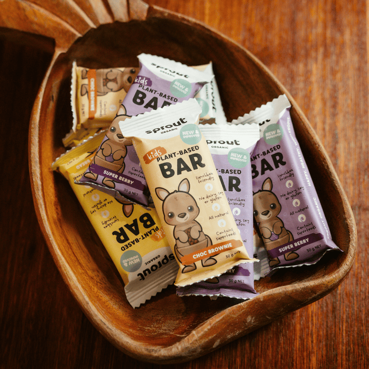 Assorted Sprout Organic Kids Plant-Based Bars in a wooden bowl