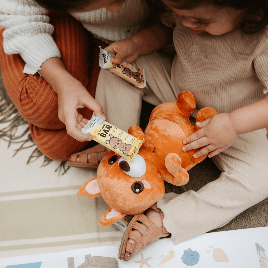 Sprout Organic plant-based snack bars held by toddler during playtime.