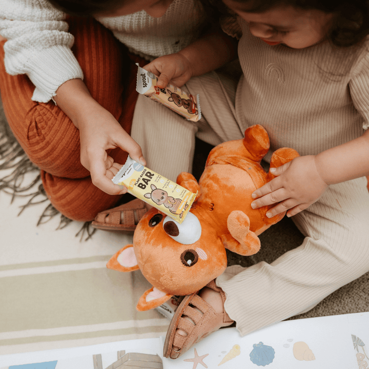 Sprout Organic plant-based snack bars held by toddler during playtime.